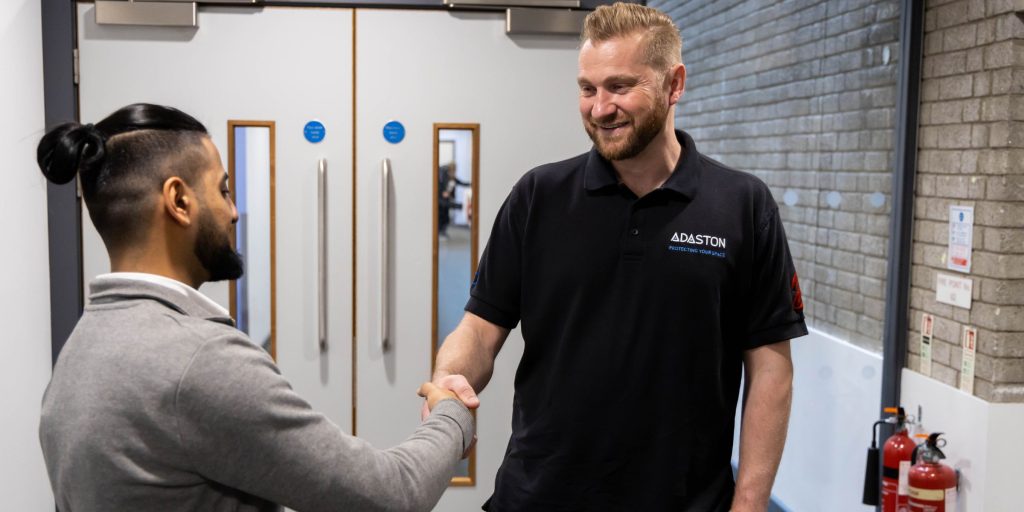 Passive fire protection expert shaking hands with healthcare staff