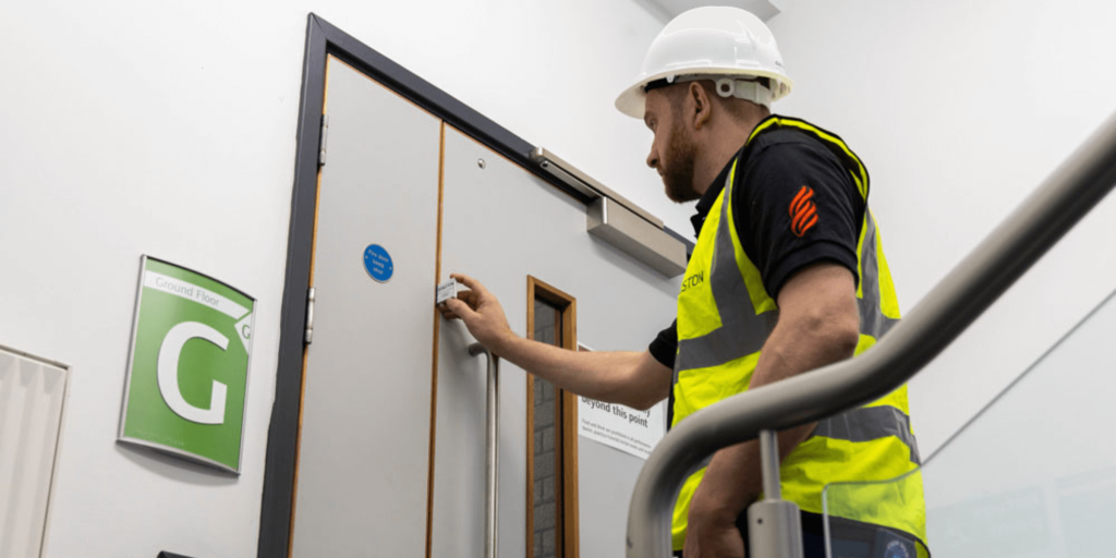 Adaston Engineer completing fire door installation